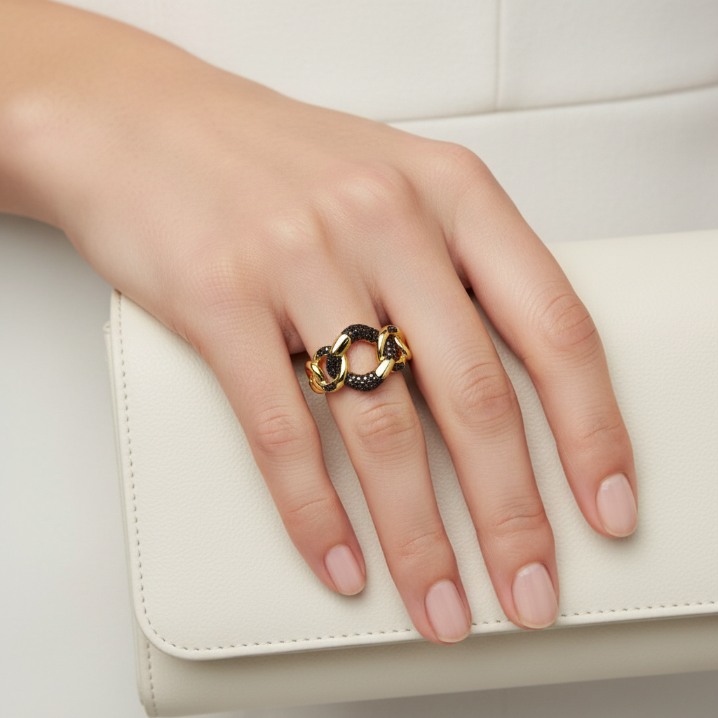 Gold chain link ring with black diamonds on finger