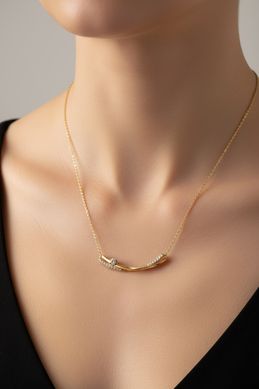 Gold curved bar necklace with diamonds on model