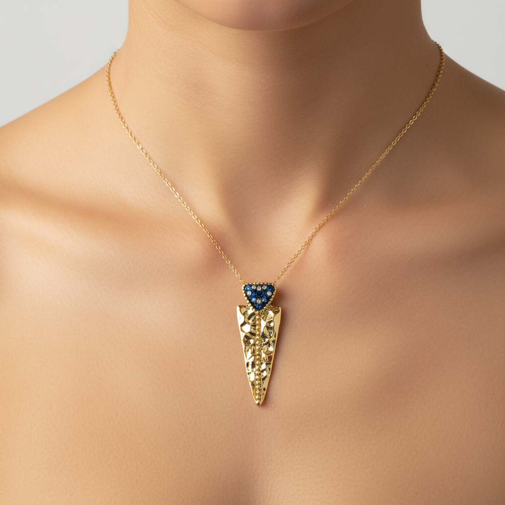 Gold filigree pendant with blue stones on model neck