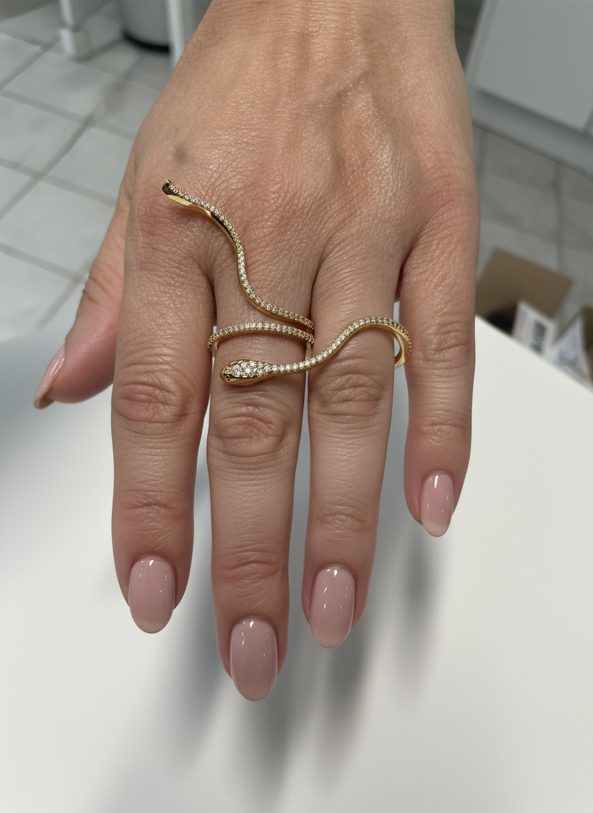 Gold snake ring on elegant hand