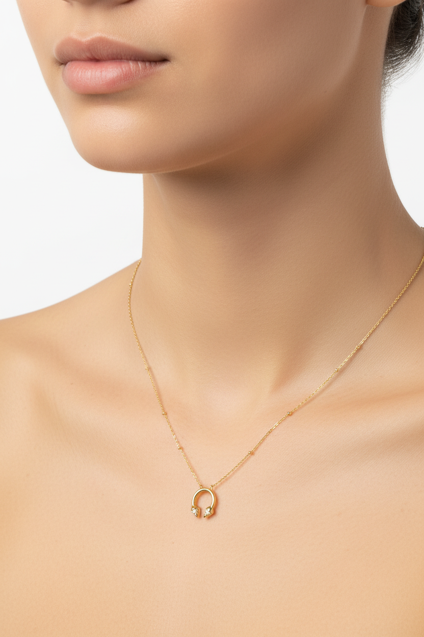 Silver horseshoe necklace worn on neck