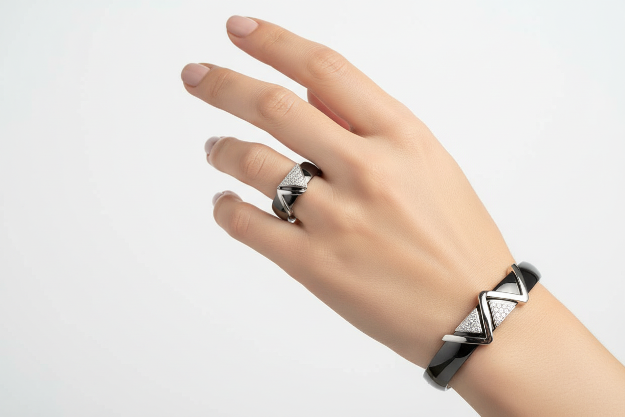 Black and silver geometric ring with matching bracelet worn on hand