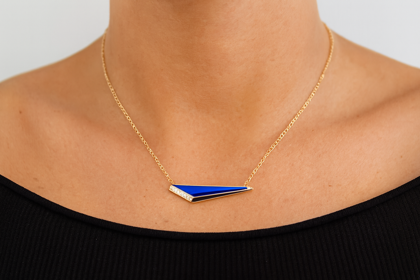 Blue geometric pendant necklace being worn