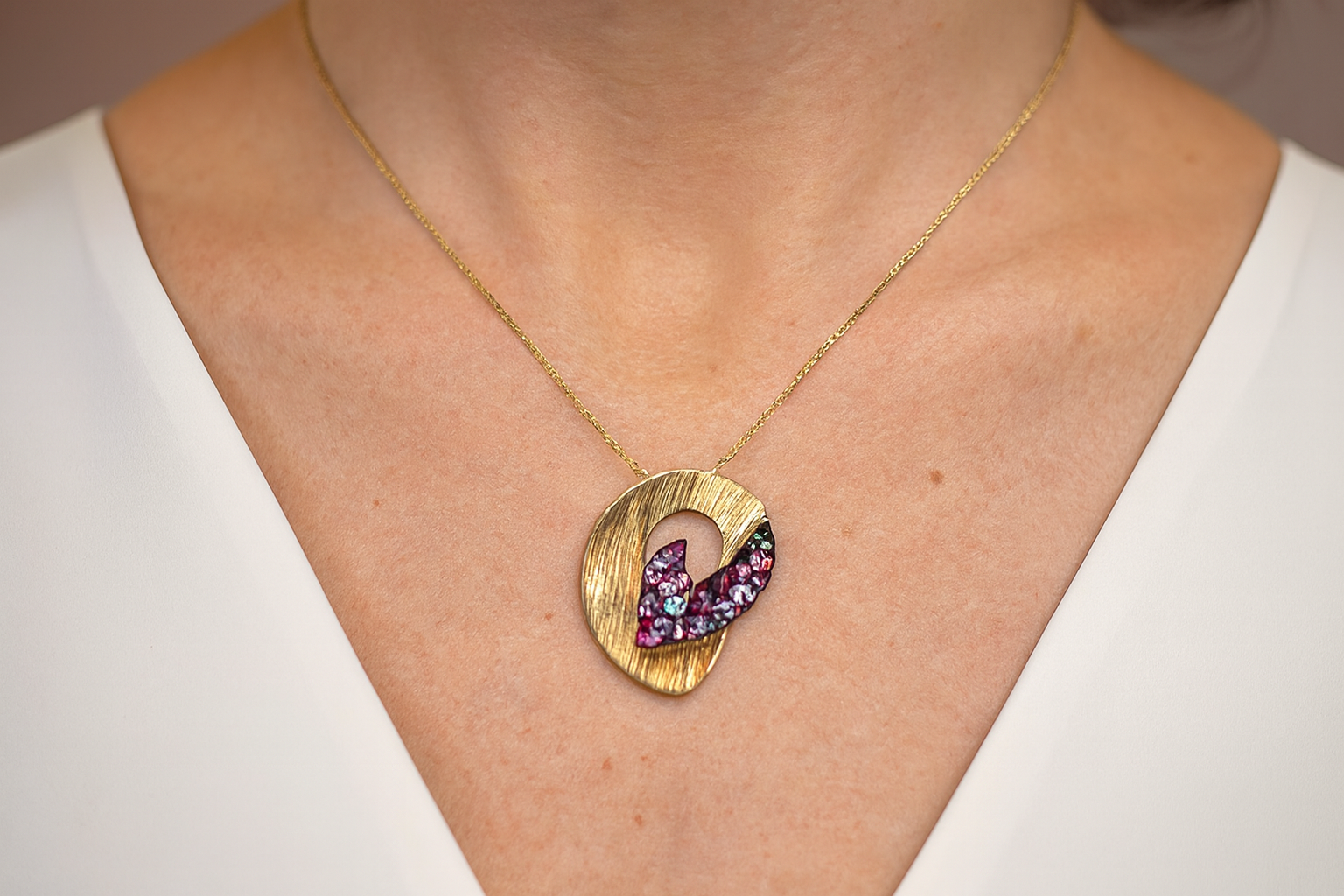 Elegant artistic pendant necklace being worn