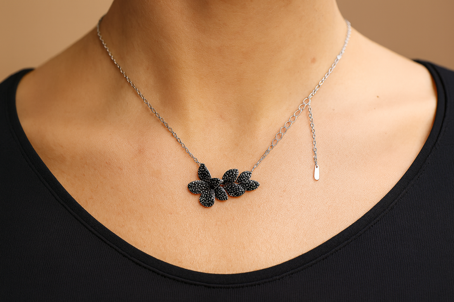 Elegant black crystal flower necklace with silver chain being worn
