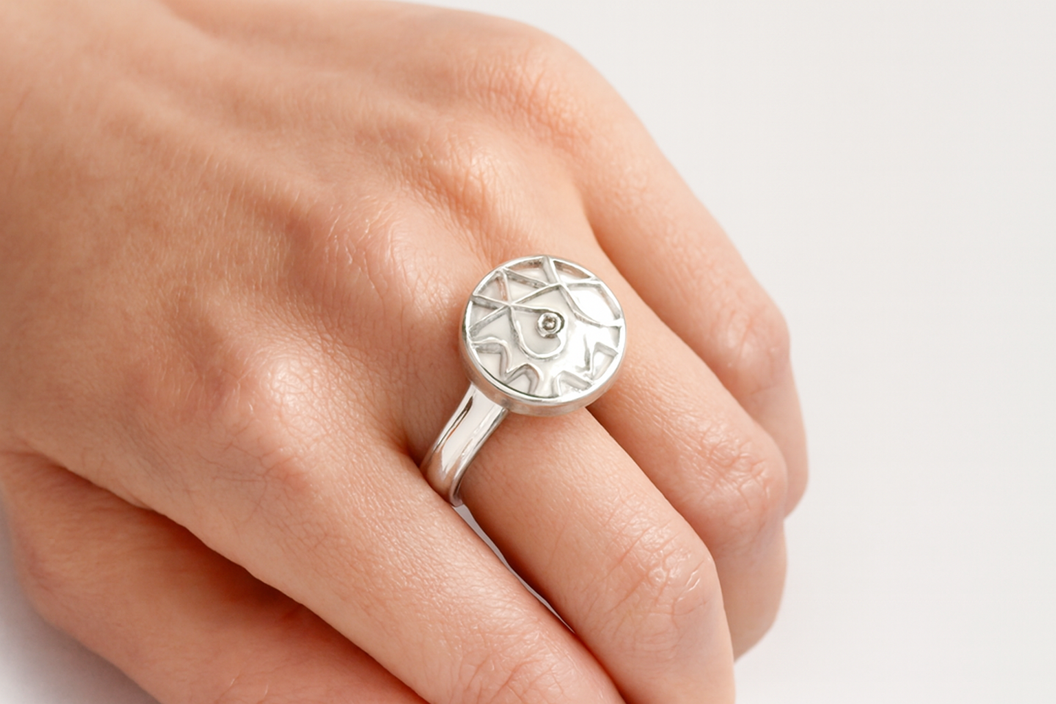 Elegant geometric patterned ring being worn on hand