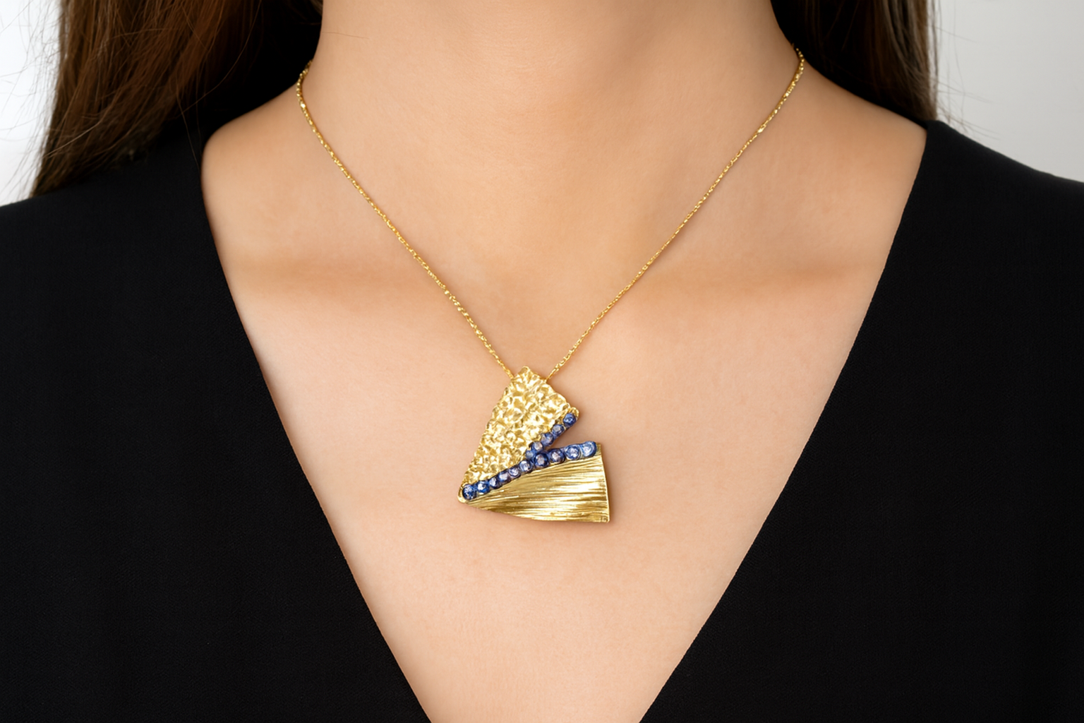 Generated lifestyle image of the geometric gold and blue crystal necklace being worn