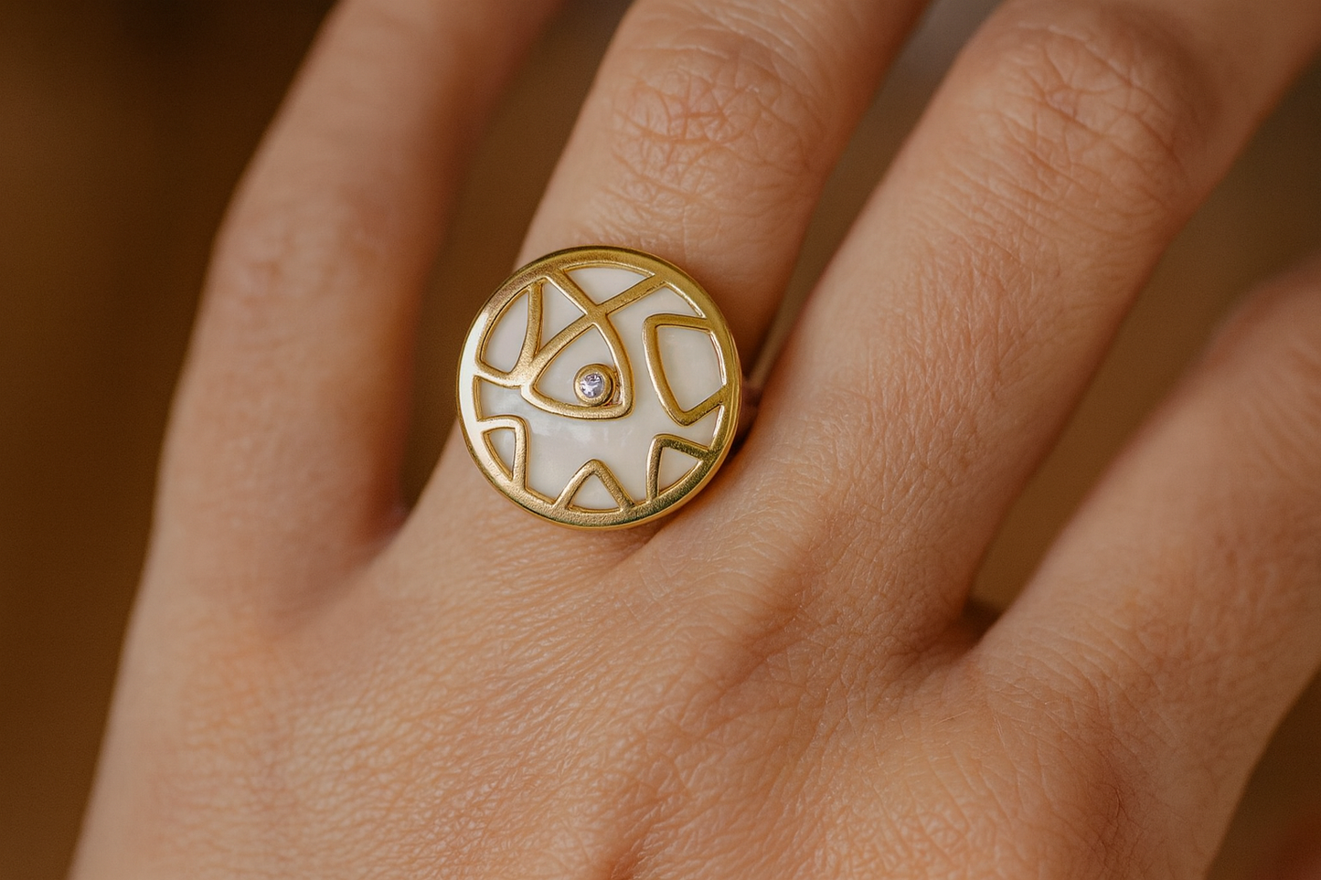 Generated lifestyle image of the geometric gold ring being worn