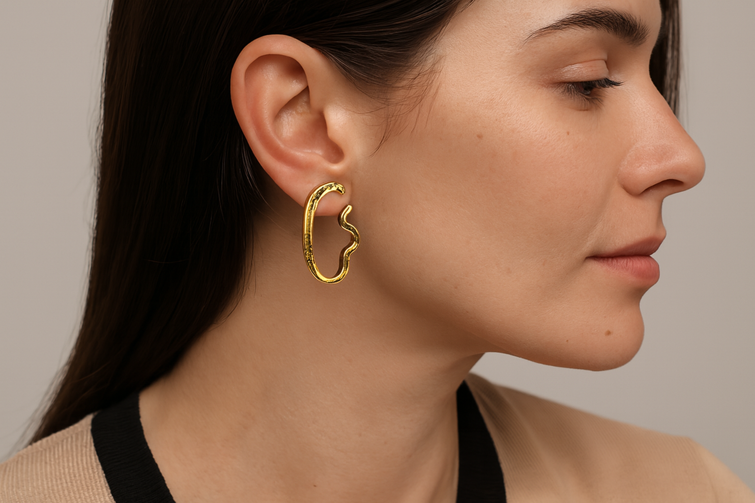 Generated lifestyle image of the organic gold earrings being worn