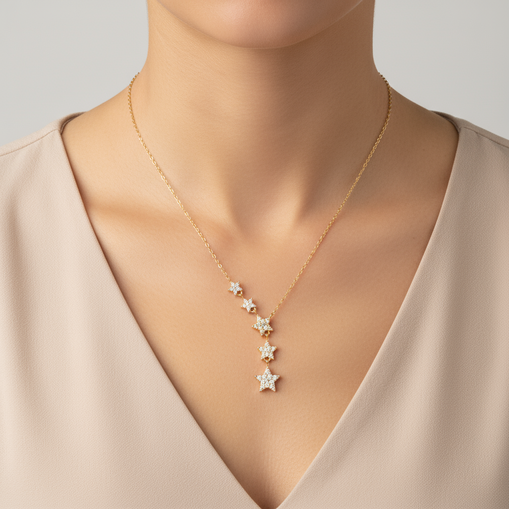 Gold cascading star necklace on model neck