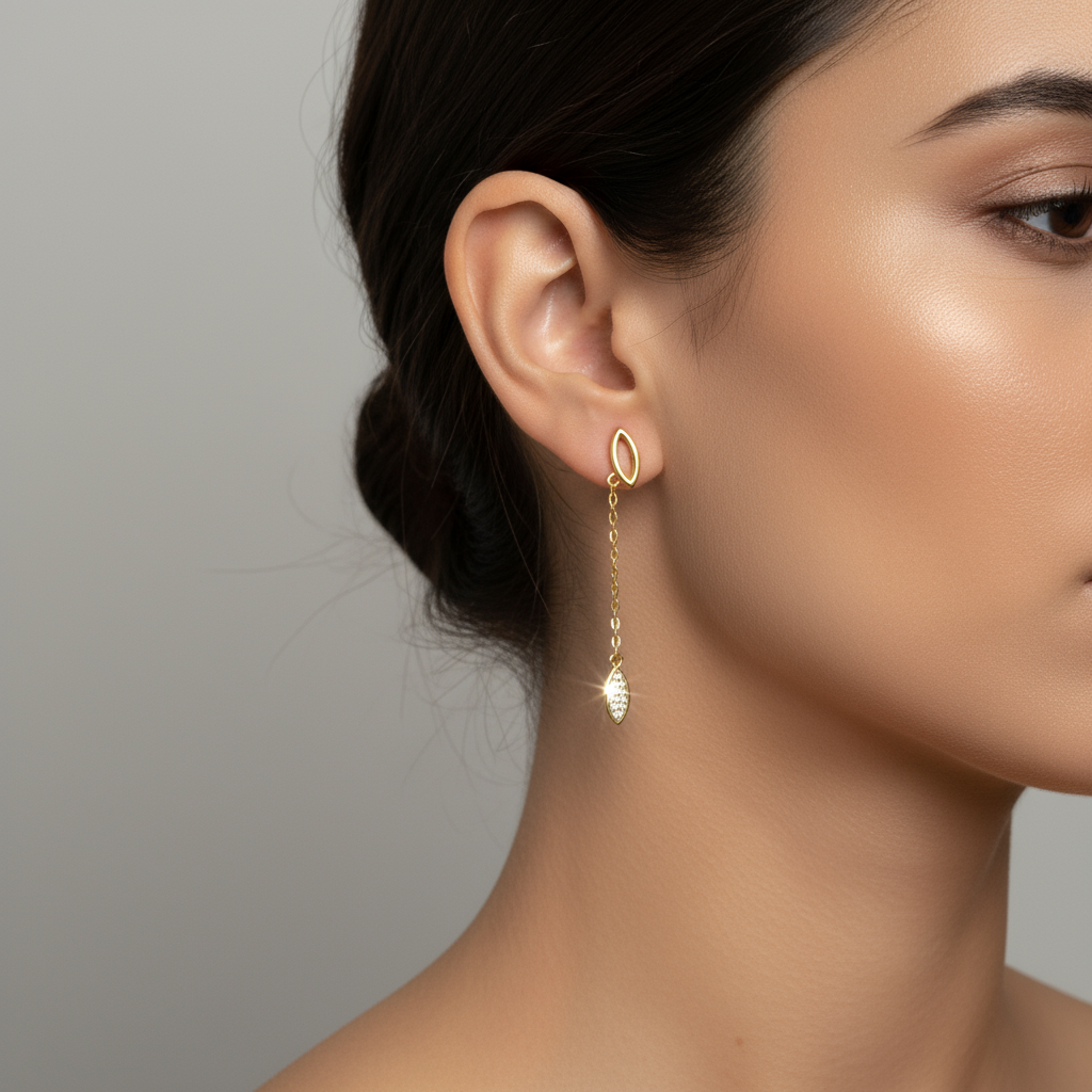 Gold chain drop earrings on model ear