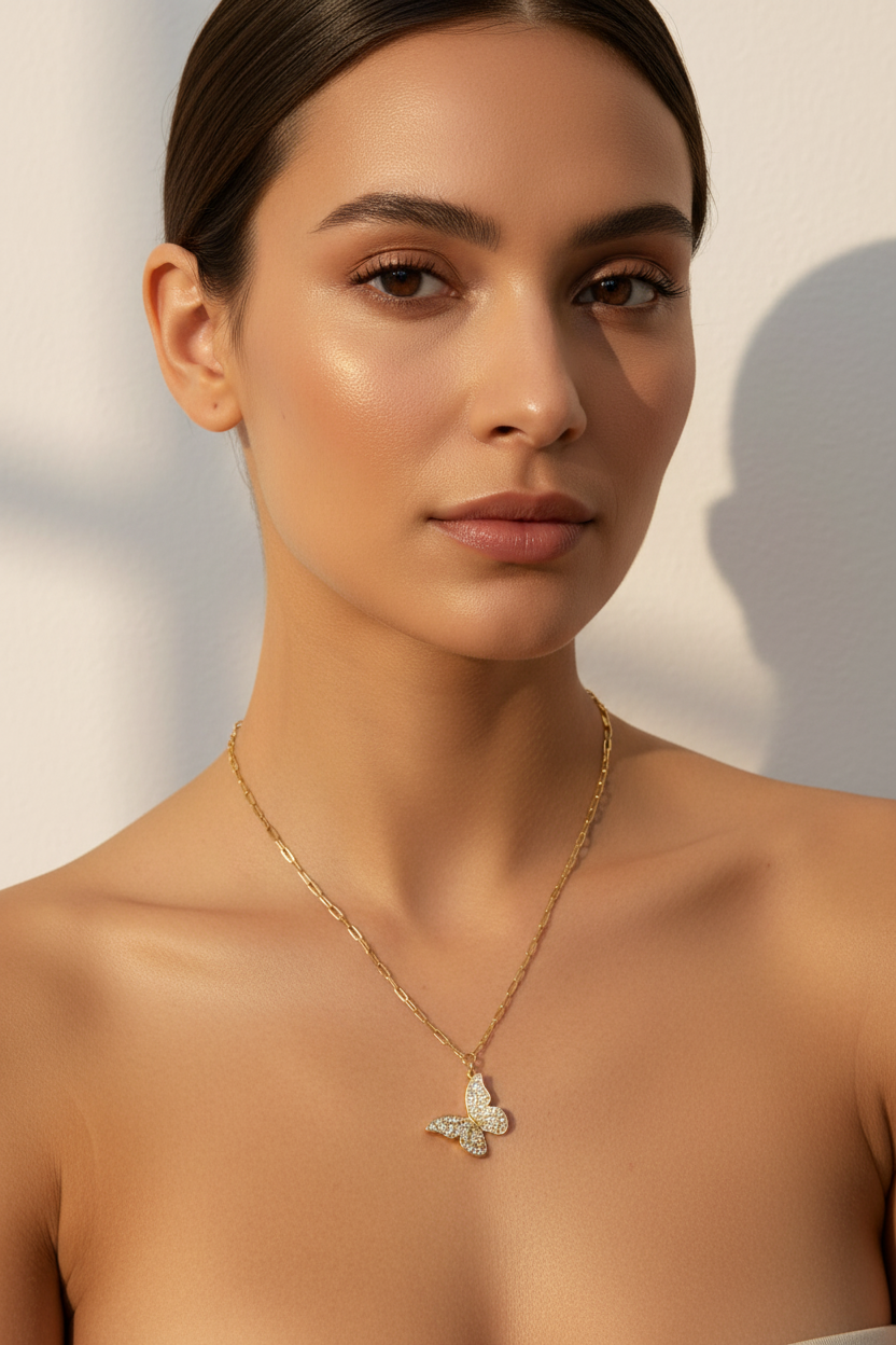 Gold crystal butterfly necklace on model