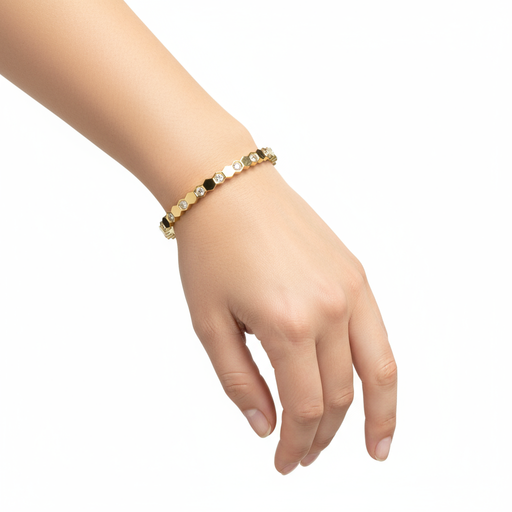 Gold hexagonal bangle on hand model