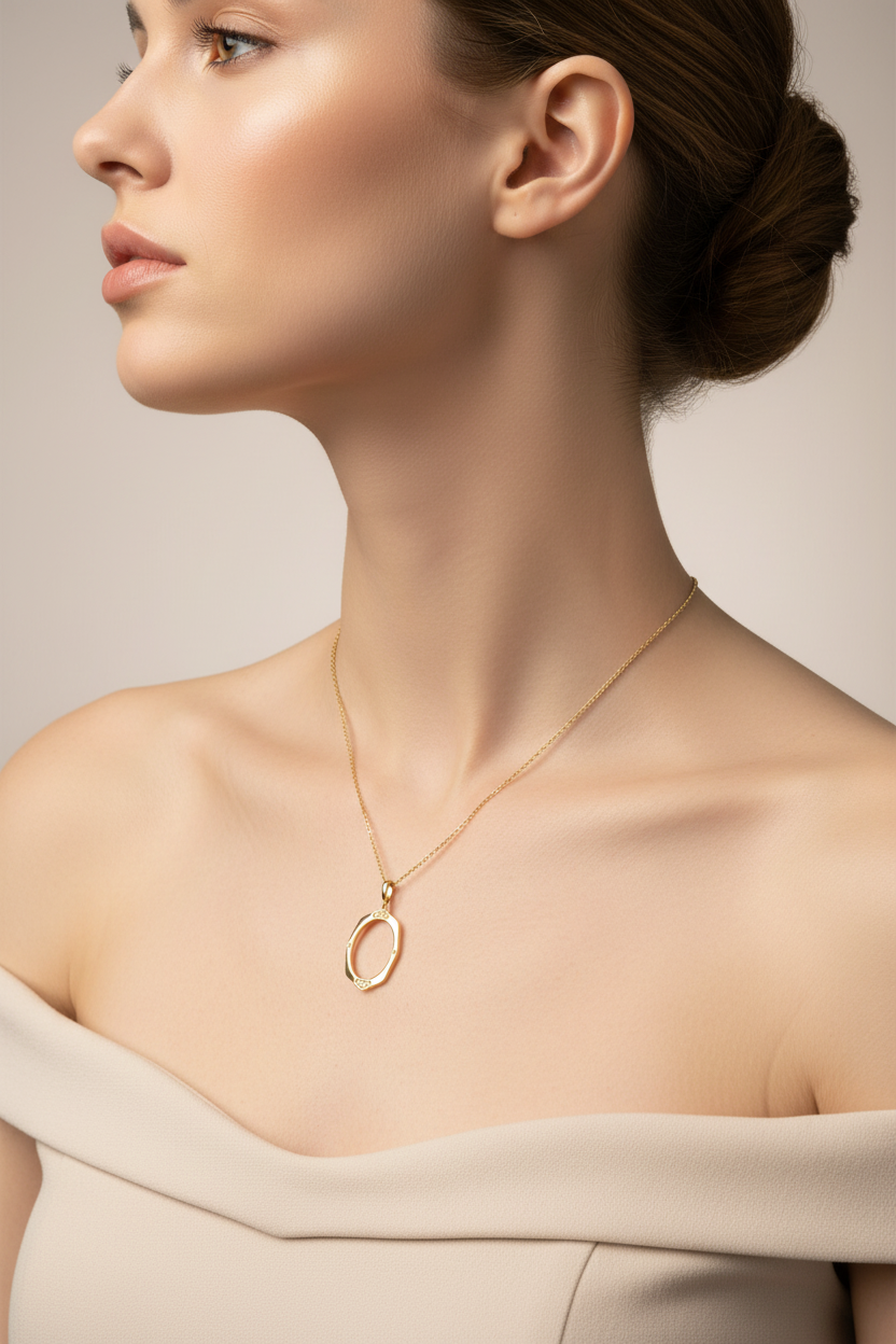 Gold oval pendant on model