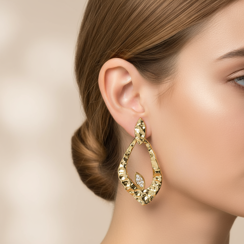 Gold teardrop earrings with diamonds on model