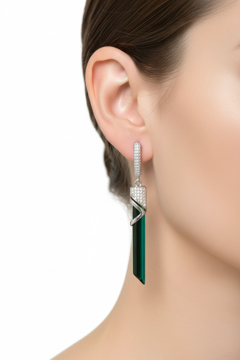 Green tourmaline drop earrings in silver worn on ear