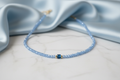 Light Blue Crystal Necklace with Elegant Background