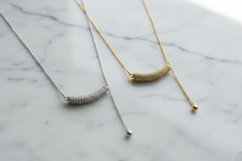 Silver and Gold Pavé Necklaces on Light Marble