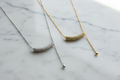 Silver and Gold Pavé Necklaces on Light Marble