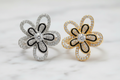 Silver and Gold Radiant Bloom Rings on Marble