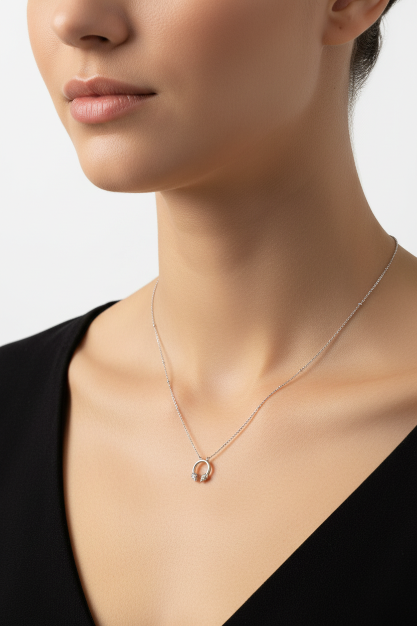 Silver horseshoe necklace worn on neck