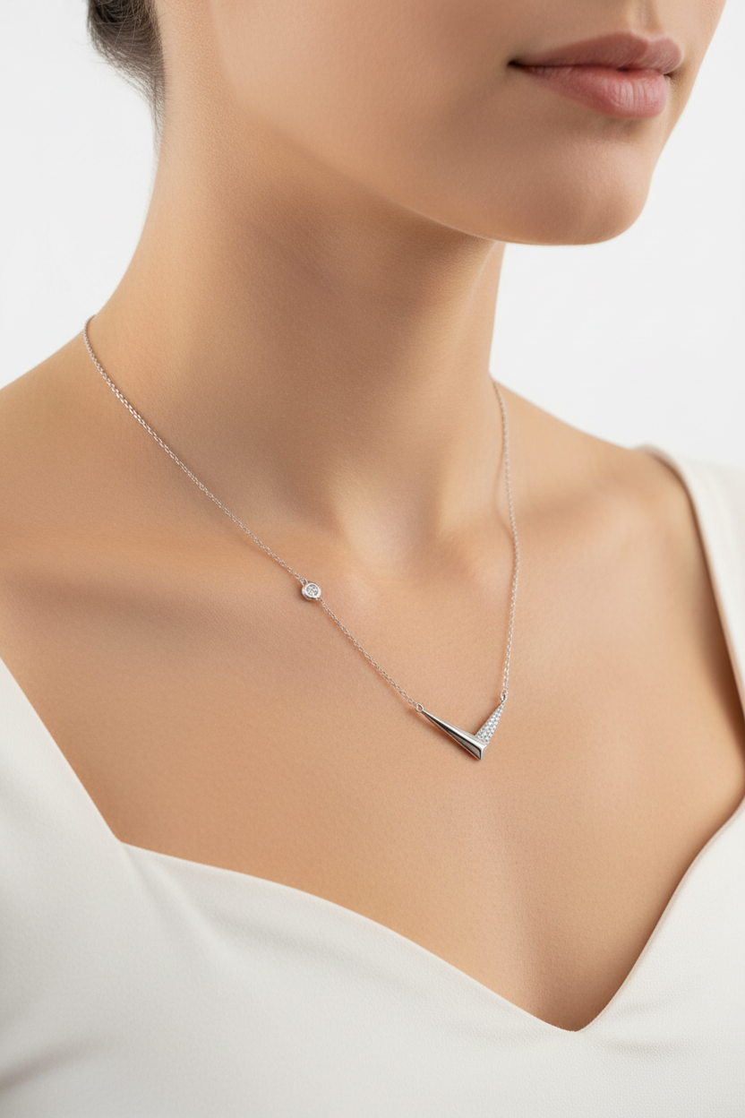 Silver V-shaped pendant necklace worn on neck