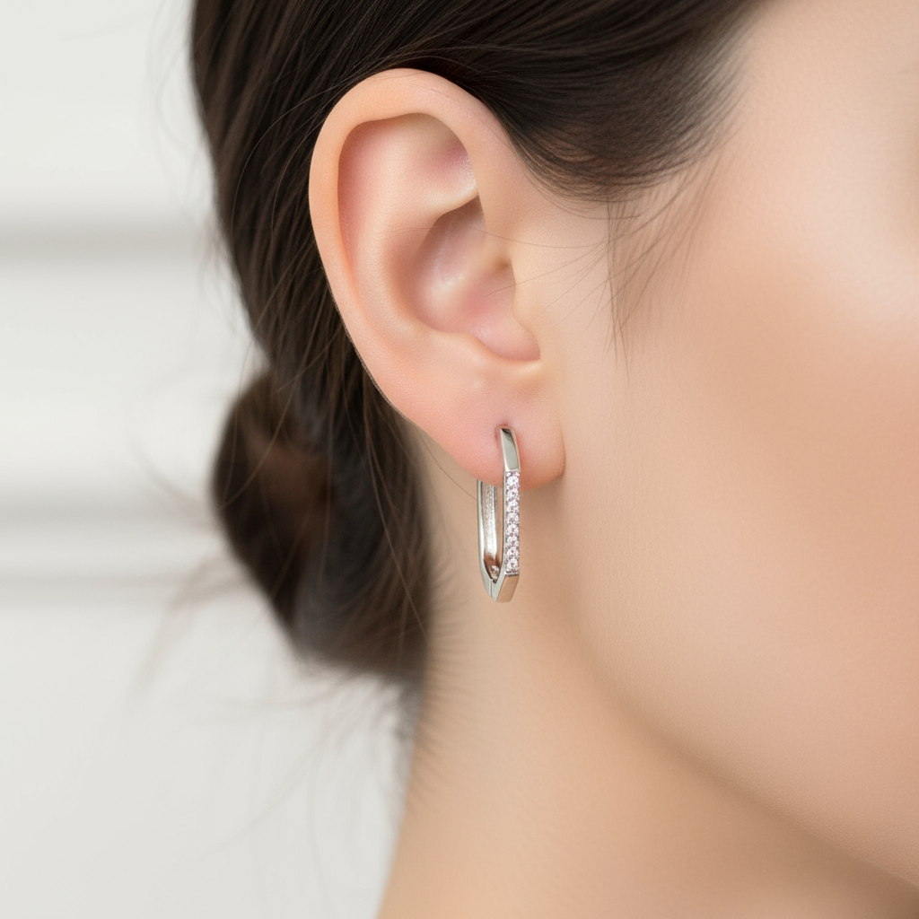 Single clear CZ hoop earring on model ear